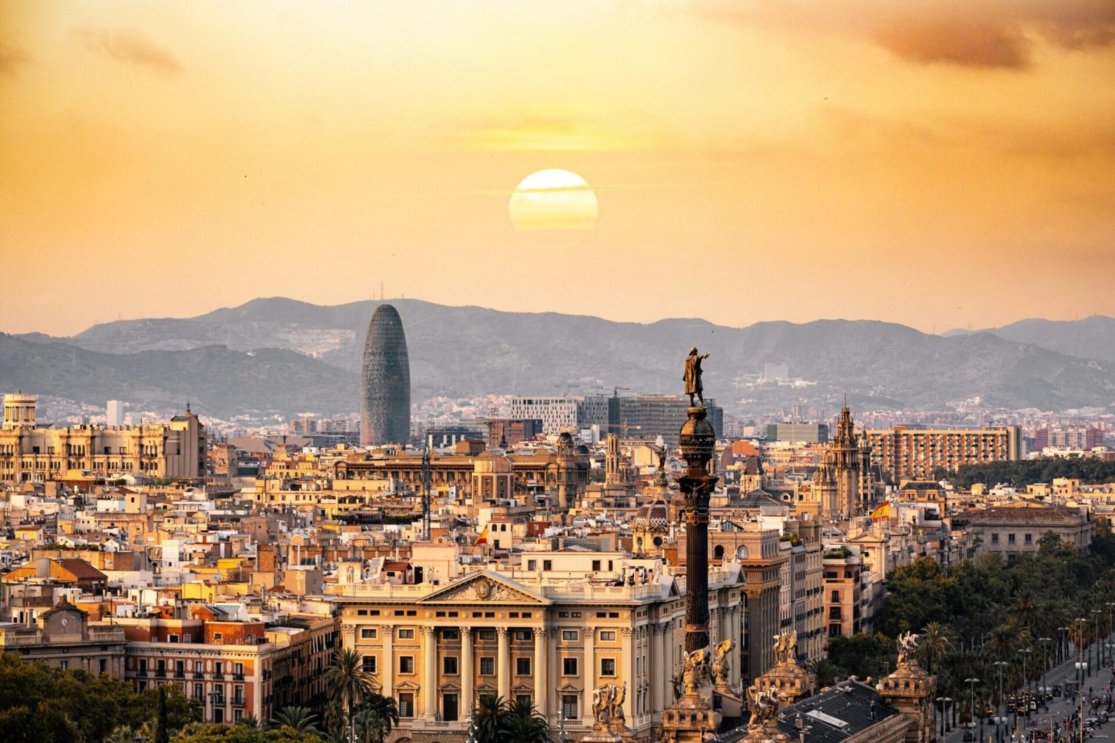 Barcelona is #5 on our list of best cities for remote work. Featured is a Barcelona sunset.