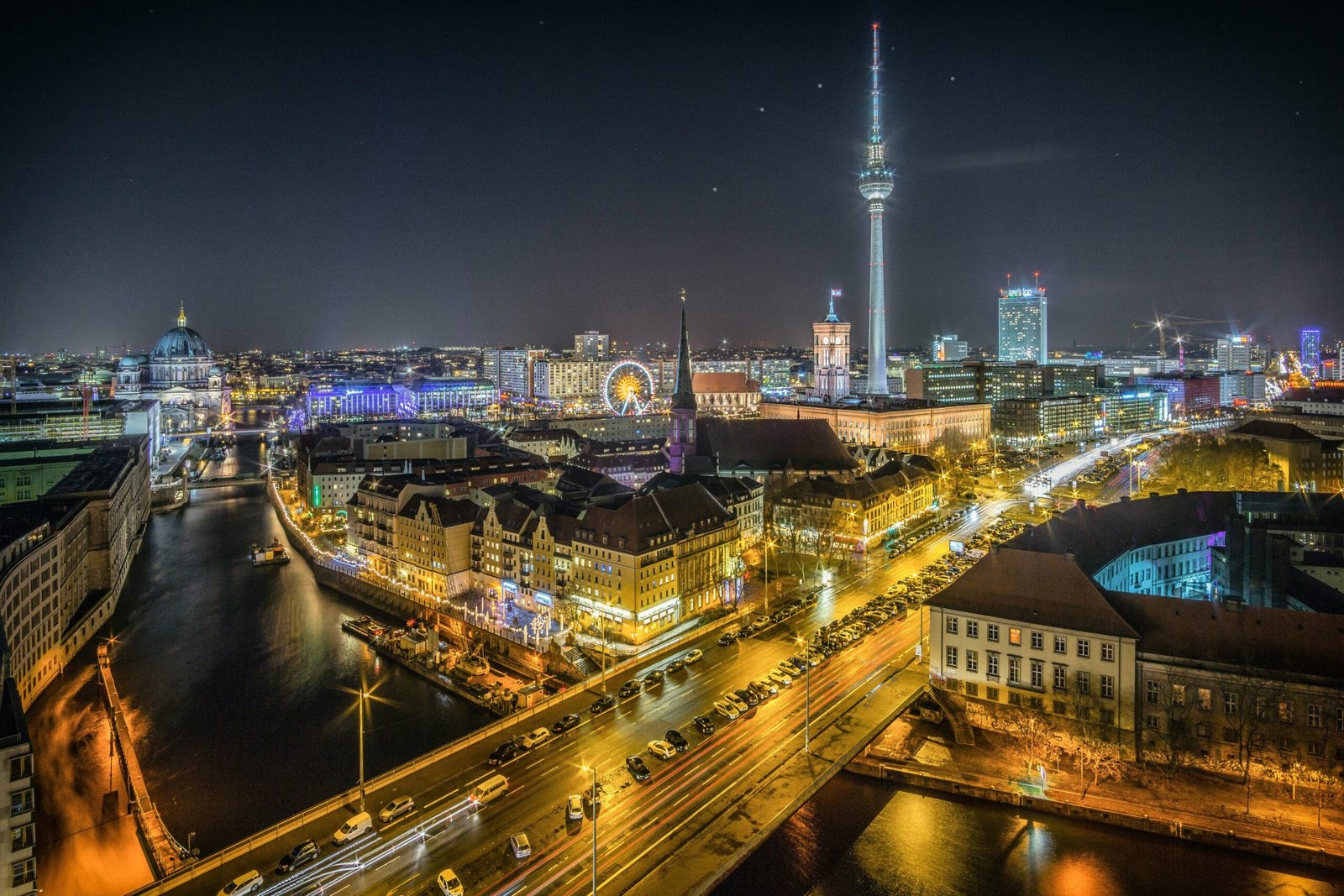 Berlin is #14 on our Europe travel bucket list. Featured is Berlin lit up at night..