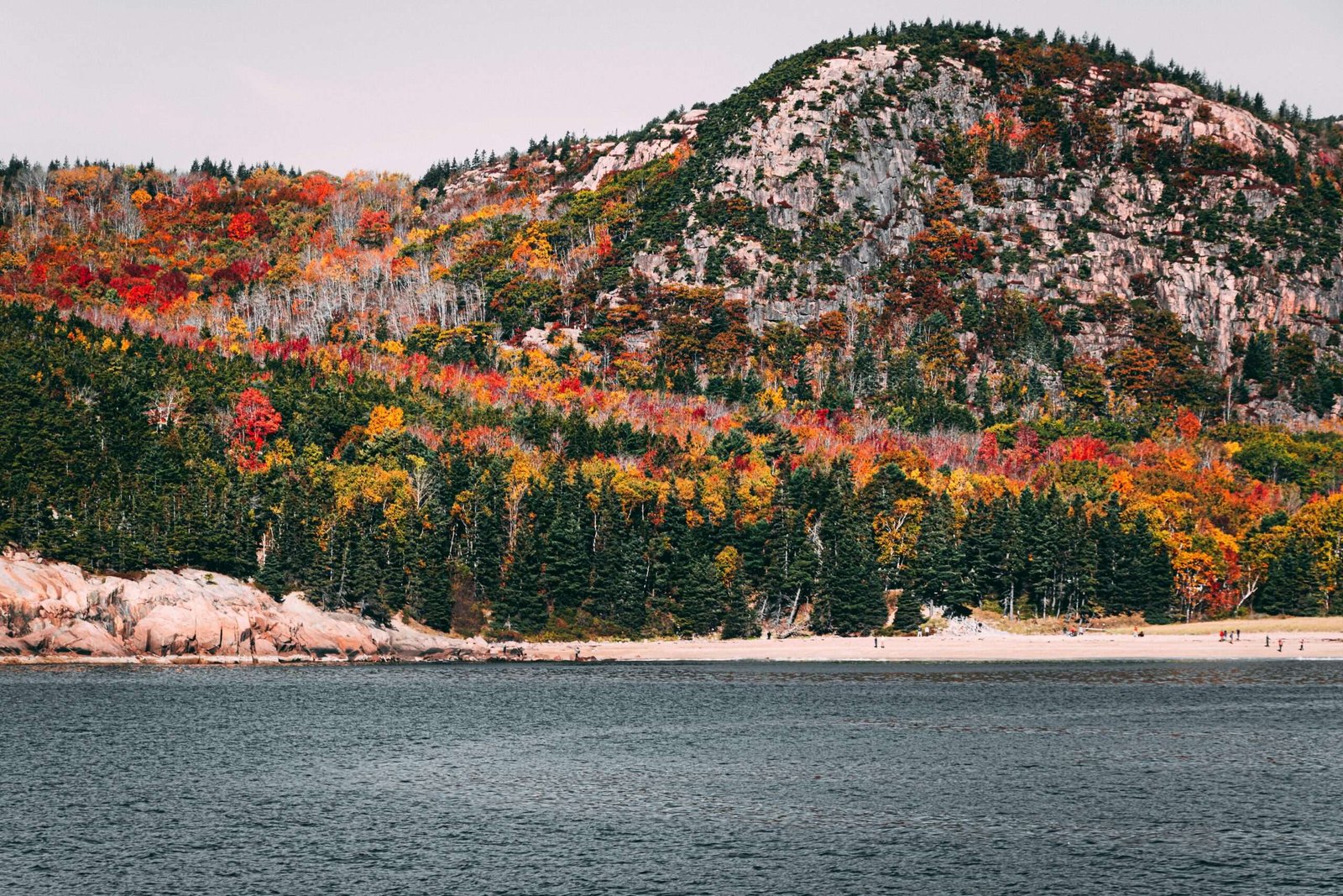 Canada is one of the best countries to travel to in October. Featured is a beautiful Canadian landscape covered in fall foliage.