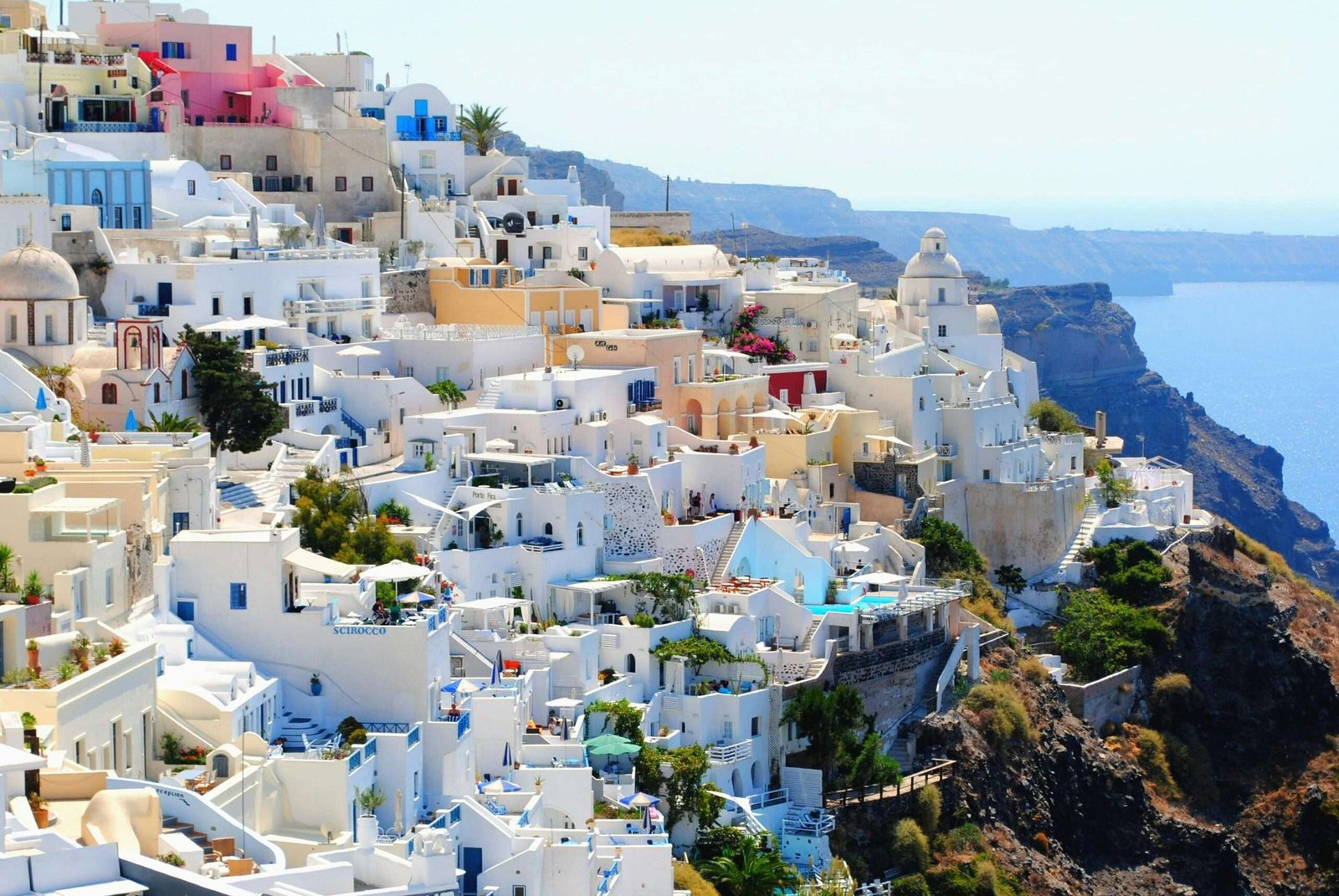 Greece is one of the best countries to travel to for beautiful islands and ancient ruins. Featured is Santorini's whitewashed buildings.