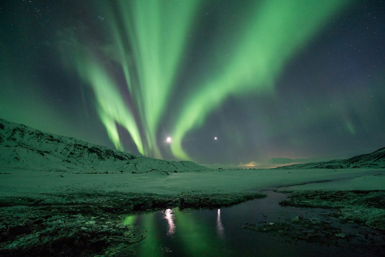 Iceland is a top country for millennial travelers. Featured is the Northern Lights over Iceland.