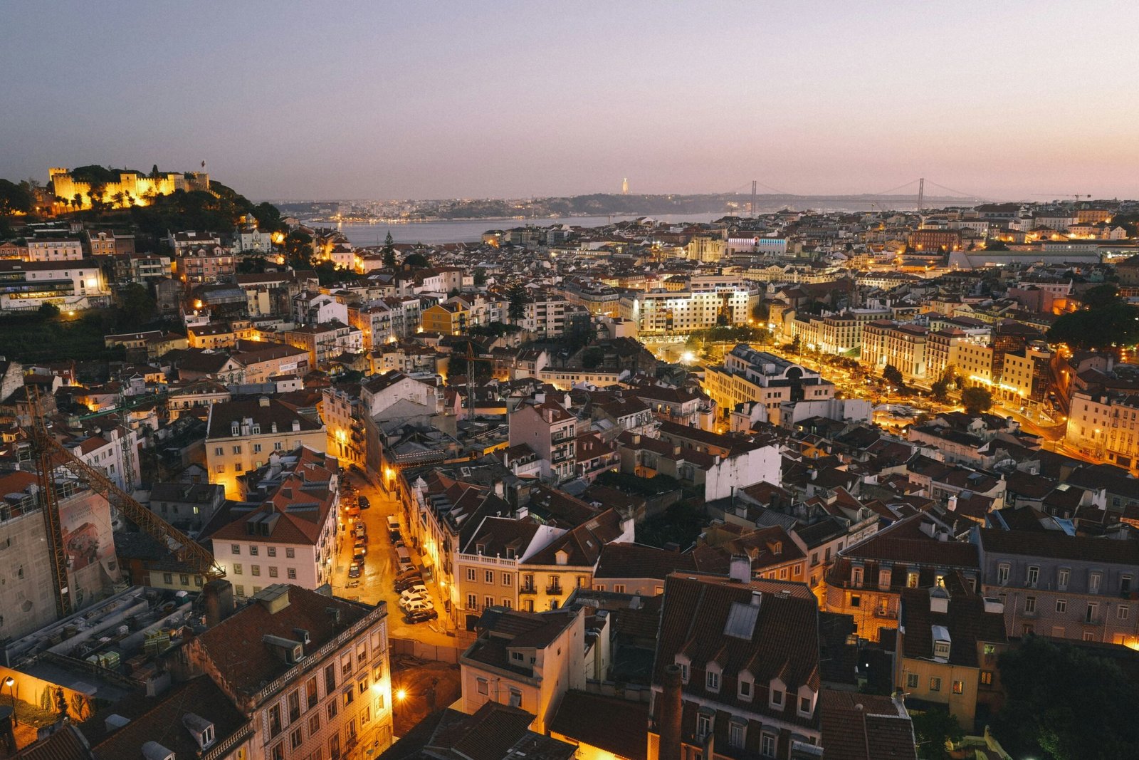 Lisbon is one of the best holiday destinations for 30-year-olds. Featured is Lisbon's cityscape lit up at night.