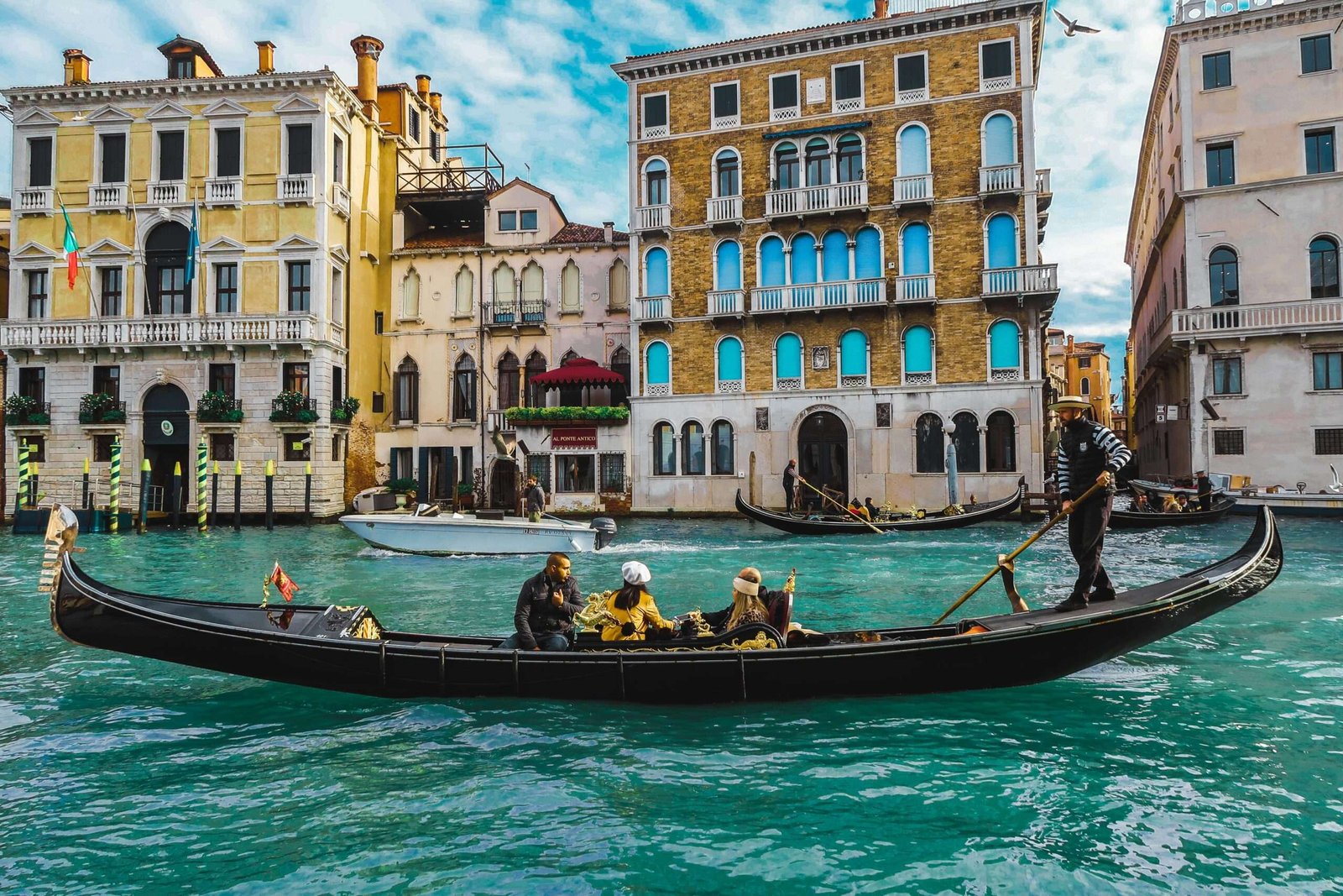 Italy is one of the best countries for first time travelers. Featured is tourist on a gondola in Venice, Italy.