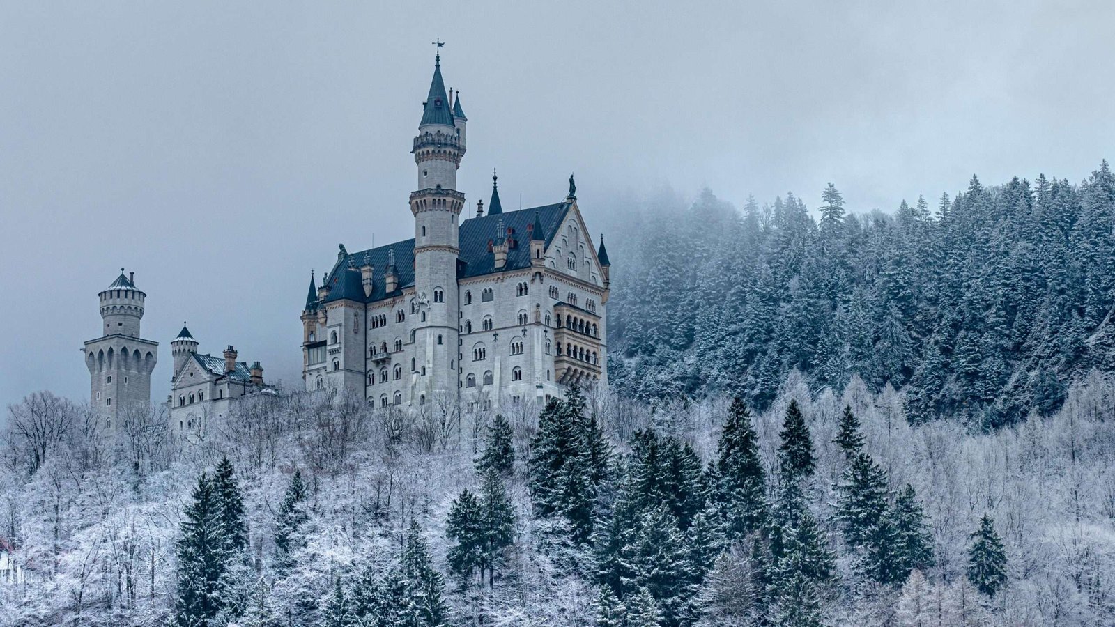 Neuschwanstein Castle is one of the must-see castles in Europe. Featured is Neuschwanstein castle covered in snow.