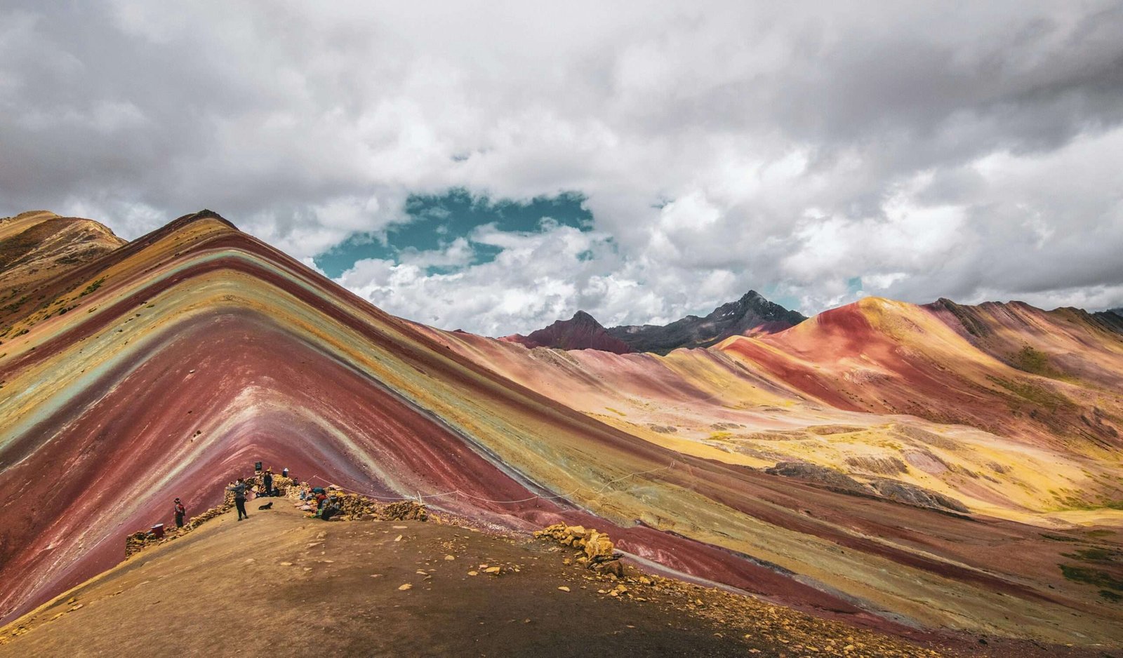 Peru is one of the best countries to visit in July. Featured is Rainbow Mountain in Peru.